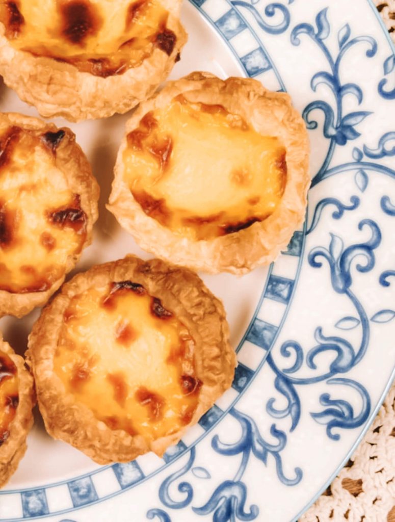 Enjoy deliscious egg tarts with cinnamon in Bélem