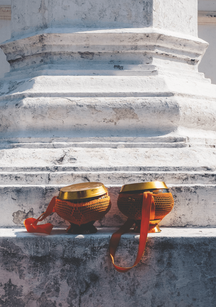 Monk bowls sitting in sun, waiting for the next round of alms