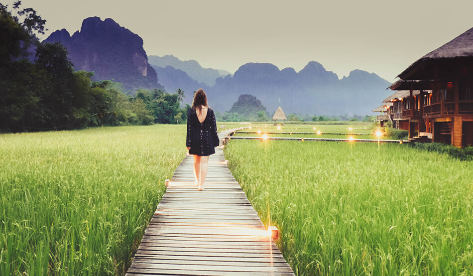 strolling through the rice fields while taking in the limestone rock formations at Vieng Tara Villa at Vang Vieng