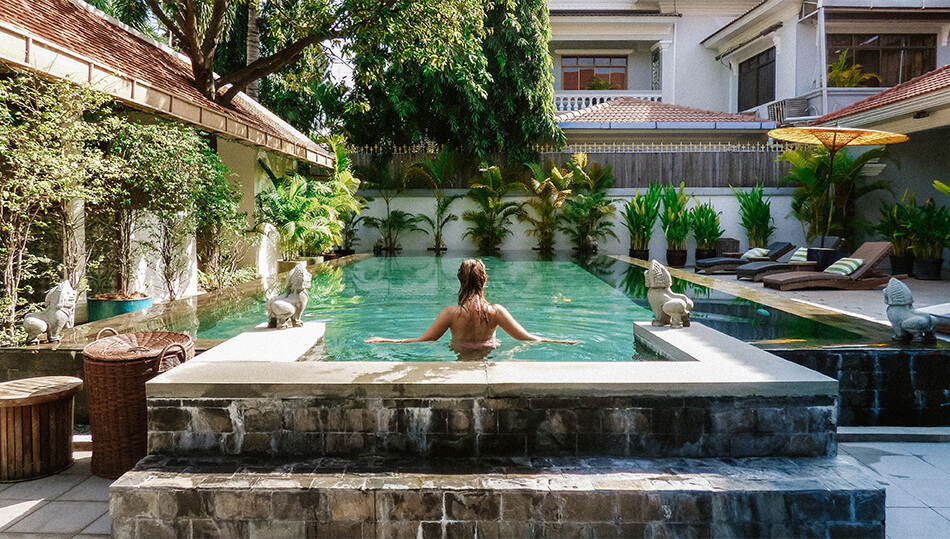 Enjoying a refreshing dip in the pool at The Pavillion in Phnom Penh, Cambodia