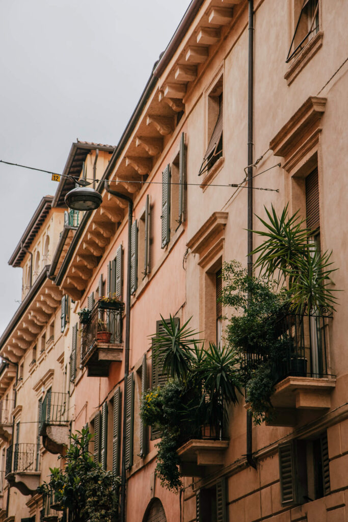 Pastel facades of beautifully preserved houses in Verona Old Town