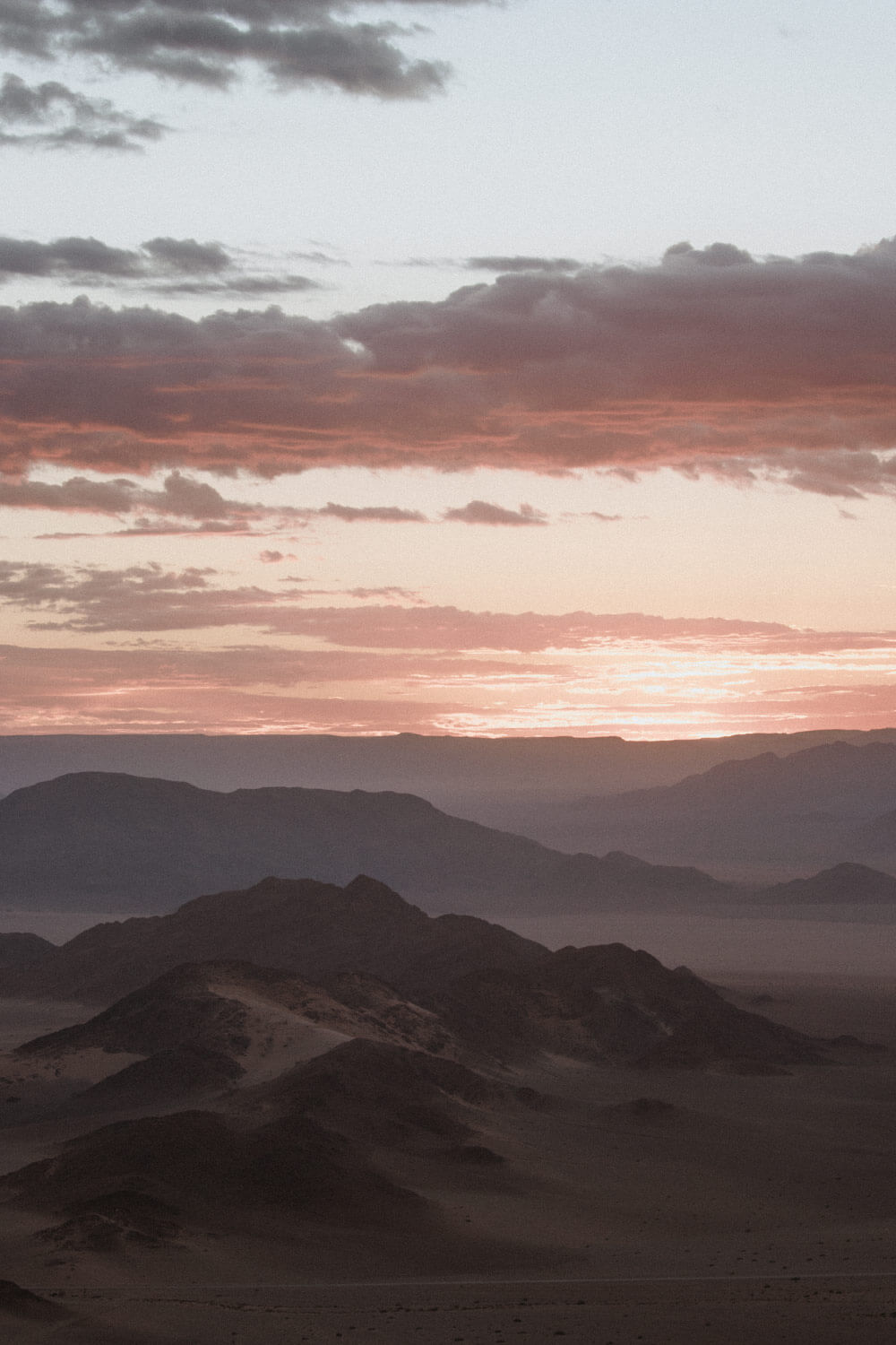 Dramatic dune landscape cast in golden light by an angelic sunrise