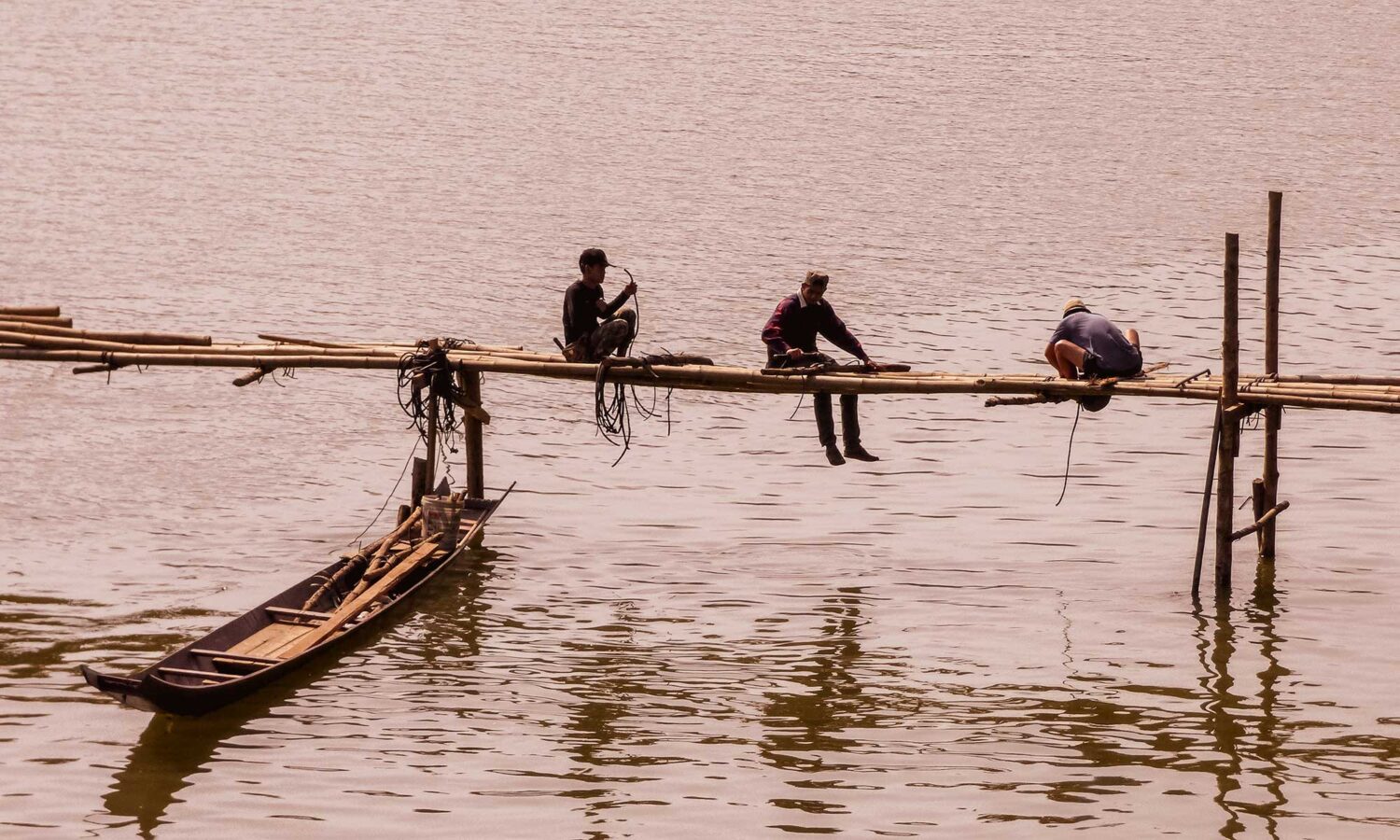 Local men building a bamboo bridge over the mighty Mekong River in Luang Prabang