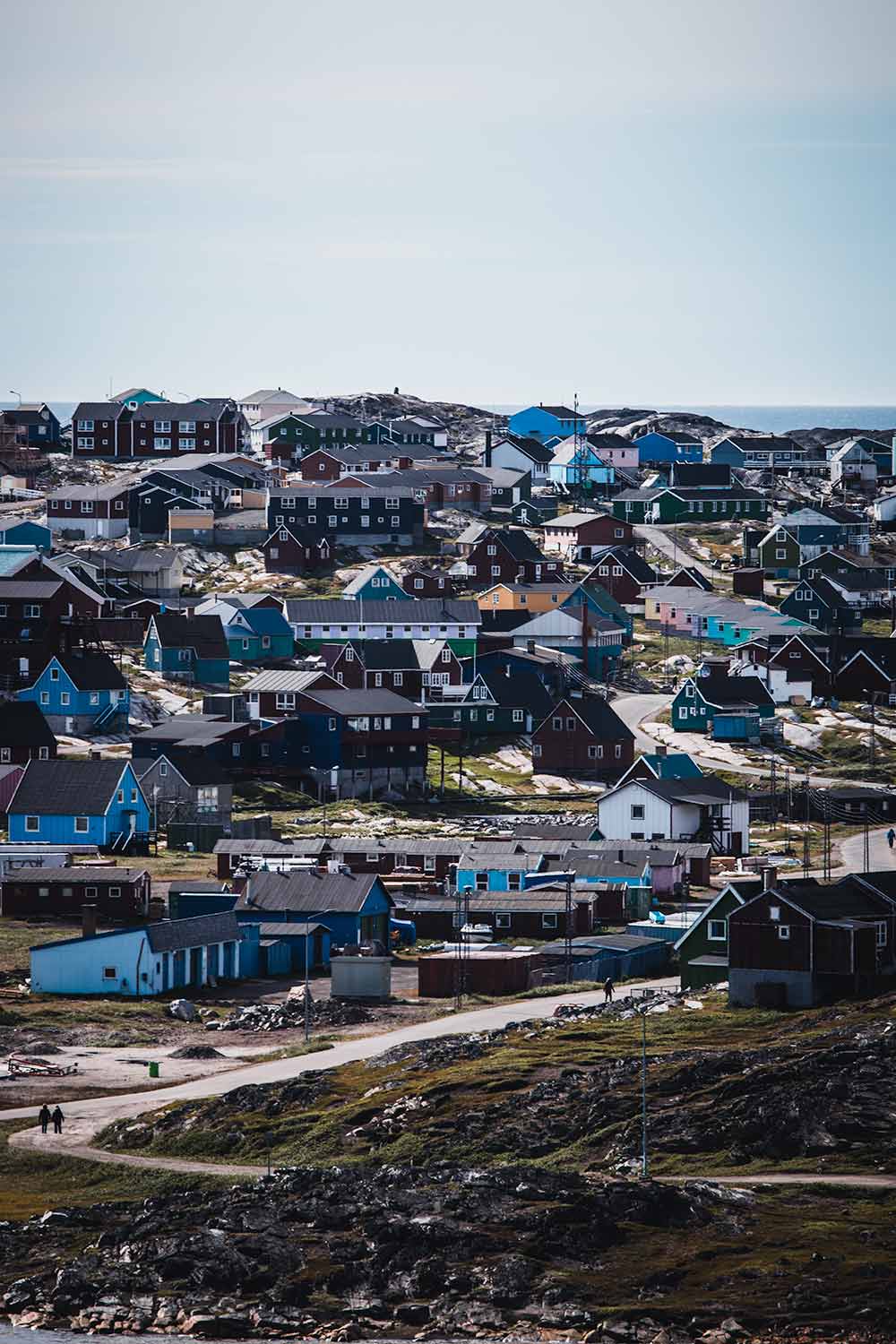 Vibrantly colored houses in Qeqertarsuaq, each hue revealing a historical significance